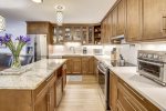 Designer kitchen with quartz counter tops and granite island 